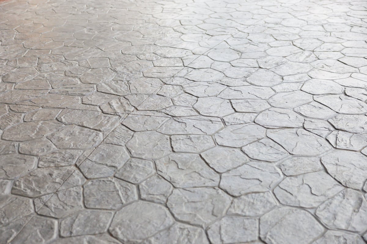 Grey stamped concrete overlay floor with decorative cement pattern texture